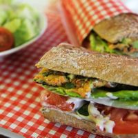 Lentils, Carrot and Herbs Omelette sandwich, with Fresh Avocado (Or Seasonal Roasted Peppers), Tahini, Carrot Spread, Cucumber, Tomato and Lettuce.  Comes with chopped salad - lettuce, tomato, radish, dressing at Cafe Landwer - Ibn Gavirol in Tel Aviv