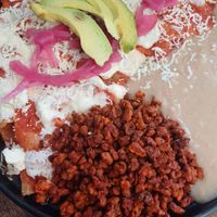 Chilaquiles acompañados de frijolitos at Alijuan Café in Mexico City