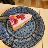 Mousse cake with a cloudberry and arctic raspberry on top at Teehuone Taigahetki in Kemijaervi