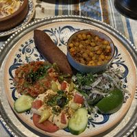 Mixed vegetarian plate (karışık vejeteryan tabak) with içli köfte (stuffed bulgur balls), spiced chickpeas, eggplant meze, and hummus.  at Mozaik Bahce in Fethiye