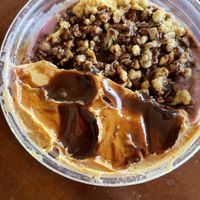 My custom toppings: crunchy sugar-free granola, peanut butter, and vegan chocolate sauce.  at Smoothie House  in Atenas