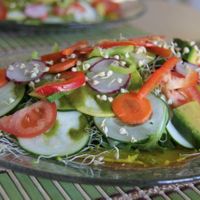 Tasty salad with piece of onion flat bread at Beauty of Sprouts. at Beauty of Sprouts in Sarasota