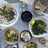 Half eaten😄chickpea croquets, garlic dip, couple of salads  at Angie seaside restaurant in Sifnos