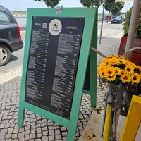The menu (you can see the lagoon across the narrow road) at Restaurante A Cozinha in Praia De Mira