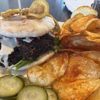 Black bean burger with fried lemon, bread and pickles made in house at Empanada Stop in Gresham