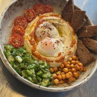 Meet our hummus & egg plate 🥚

Creamy hummus topped with perfectly boiled eggs, a drizzle of olive oil, and a touch of black sesame. Served with fresh, crunchy veggies on the  at OOFT Coffee in Berlin