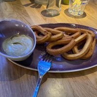 Churros with pistachio cream: amazing! Tasty and not too sweet or greasy. The sauce is creamy at Hans Im Gluck - Rembrandtplein in Amsterdam