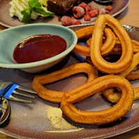 Churros with berry puree. at Hans Im Gluck - Rembrandtplein in Amsterdam