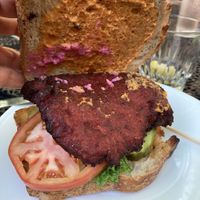old major house burger made with cannellini beans and beets and a vegan sauce. Made vegan by swapping out the milk-based bun with vegan sourdough bread and holding cheese sauce at Heart of Gold in Cleveland