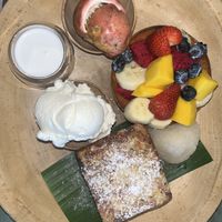 Mango French toast with a fruit bowl, coconut ice cream, coconut milk and sticky rice + peach iced tea (not pictured) best I’ve ever had!  at Mango in Bangkok
