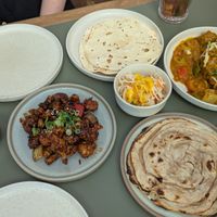 a few vegan dishes: pickles, cauliflower popcorn, breads, coleslaw, mushroom tikka masala at Authentikka Winterhude in Hamburg