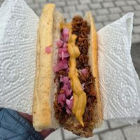 Vegan hot dog with vegan bread topped with crispy onions, pickled onions and mustard at Raketten Bar & Pølse in Troms