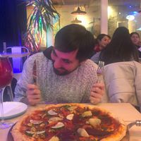 This just demonstrates how much we love their pizzas (and the bf was over me taking food pics).  at Bar Galería Aura in Concepcion