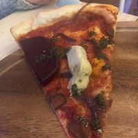 You can really see from this slice just how thin the pizza dough actually is.  at Bar Galería Aura in Concepcion