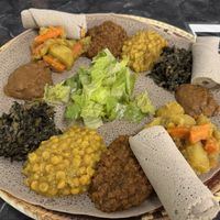 Veggie Combo - shiro (thick seasoned legume sauce/gravy), alcha kik (turmeric yellow lentils/chickpeas), gomen (greens), misir (red lentil stew) + injera    at Lalibela Ethiopian Cuisine in Redding