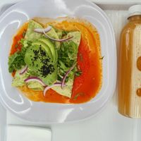 Enchiladas and agua fresca melon at La Buena Tierra Antara in Ciudad De México