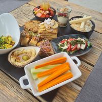 Breakfast platter, tofu scramble, pancakes, fruit salad, vegetable roll, homemade mozzarella, porridge, yoghurt with granola and berries at Villa Vegana in Mallorca