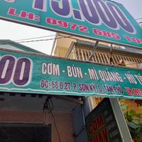 Old faded sign outside at Com chay Vạn Duyen in Ho Chi Minh City