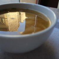 Miso soup with the reflection of a beautiful building in it.  at Rizsa17 in Budapest