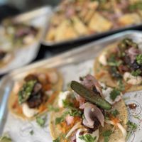 Ribs Tacos (and a full tray of nachos blurry in the back)  at Club Mexicana in West London