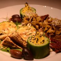 Snack Platter (Part 2)-- fava bean & mushroom pâté, fried tofu, cucumber cups with cashew cream, grilled zucchini with cashew cheese, sun-dried tomatoes, olives at Vegan Restoran V in Tallinn