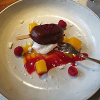 Passionfruit “cheesecake bite” with mango & raspberry sauce and meringue at Vegan Restoran V in Tallinn