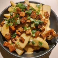 Fries with vegan cheese sauce and tofu. at Vegan Restoran V in Tallinn
