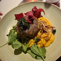 Quinoa turnip cutlet with roasted carrot puré and warm bean cabbage salad  at Vegan Restoran V in Tallinn