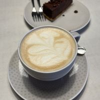 Latte and chocolate cake  at Vegan Restoran V in Tallinn