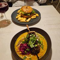 Vegan pineapple burger and peanut-orange-marinated soy skewers with noodles and curry at Vegan Restoran V in Tallinn