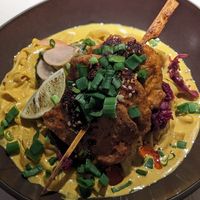 🍢 Peanut-orange marinated soy skewers in a slightly spicy curry sauce with rice noodles and red cabbage kimchi - (15€) at Vegan Restoran V in Tallinn