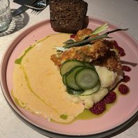 Breaded ´´chicken´´ with herb sheese, potato puree, sun-dried tomato sauce, pickles and Estonian style bread.  at Vegan Restoran V in Tallinn