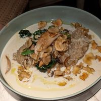 King oyster mushroom risotto with kale and bimi in a white wine sauce with peanut chips at Vegan Restoran V in Tallinn