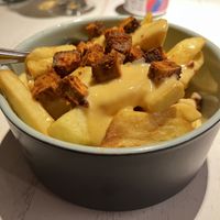 fries with vegan cheese sauce and tofu bites  at Vegan Restoran V in Tallinn