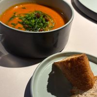 Tomato and bell pepper puree soup with olive focaccia and crispy chickpeas at Vegan Restoran V in Tallinn