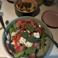 Watermelon feta salad, cheese bacon fries at Vegan Restoran V in Tallinn