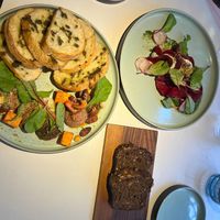 Charcuterie, beet ravioli and dark breadd  at Vegan Restoran V in Tallinn