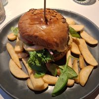 September 2025 - Burger with Peas Out patty, baba ghanoush, pickled onion, tomato, green salad  with sheese sauce and fries at Vegan Restoran V in Tallinn