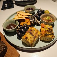 Snack platter: handcrafted cashew sheeses: chipotle pepper and truffle flavor, homemade jams: cognac-cranberry-orange red wine onion-plum, pâté, rosemary bread, crackers at Vegan Restoran V in Tallinn