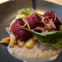 Jackfruit-beet-chickpea balls with potatoes, smoky onion cream and herb hummus at Vegan Restoran V in Tallinn