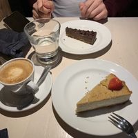 Rich chocolate cake & baked tofu cake + cappuccino  at Vegan Restoran V in Tallinn
