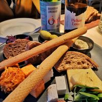 Cheese platter for two: (starter) Cashew cream cheese, peanutbutter-cheese ball, grilled vegan halloumi, vegan greek style cheese, vegan cheese, olives, onion jam, grissini, ciabat at Vegan Restoran V in Tallinn