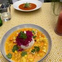 Chickpea, sweet potato and cauliflower coconut curry - Smoky tomato and cheese puree soup with vegan parmesan at Vegan Restoran V in Tallinn