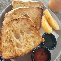 Ciabata with jam and hash browns at Chill At Portofino in Palm Cove