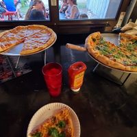 One plain vegan pizza and one with spinach at Pleasant Street Pizza Pub in Gainesville