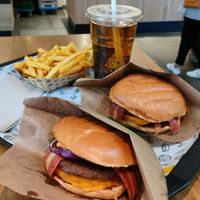Two Vincent super mash burgers with extra bacon, crunchy fries and ginger ale at VINCENT -  Hauptbahnhof in Berlin