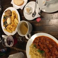 Goulash soup, homemade bread, seitan stew, and oven-baked veggie plate  at Kozmosz Vegan Etterem in Budapest