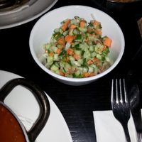 Israeli Salad comes with the Vegetable-patty in Tomato,  plus  Tahini, plus Olives at Café Schneor in Tel Aviv