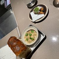 glazed focaccia with artichoke dip, bbq corn behind  at lara  in Vienna