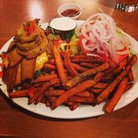 Oklahoma Bacon Cheeseburger with a side of sweet potato fries at Native Foods - Point Loma in San Diego